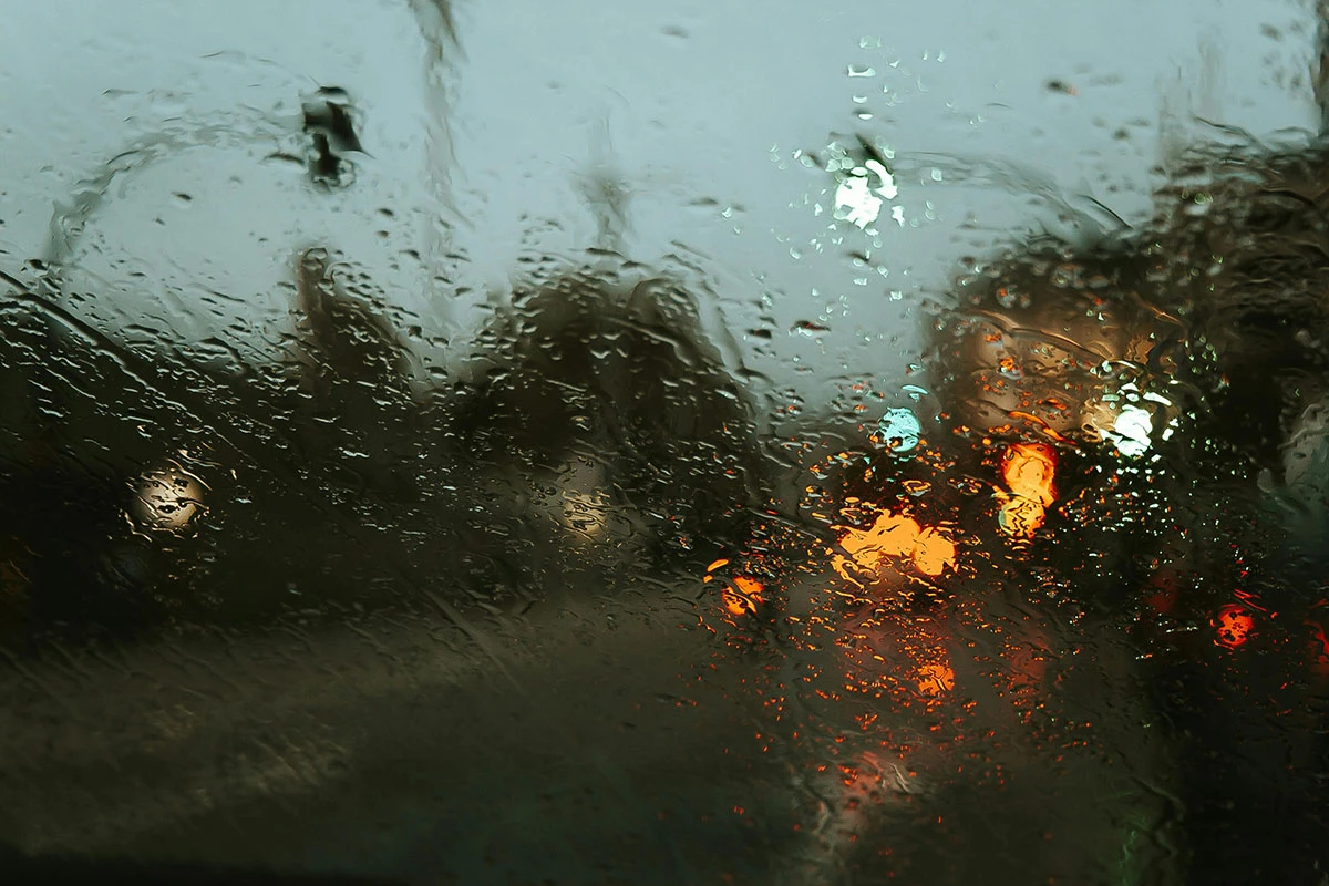 Rain on road through window